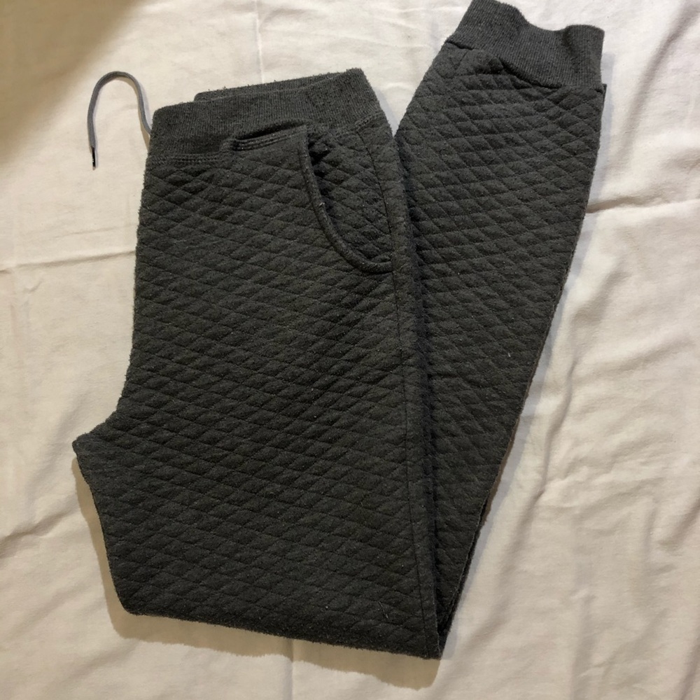 Grey patterned sweatpants (jogger style).